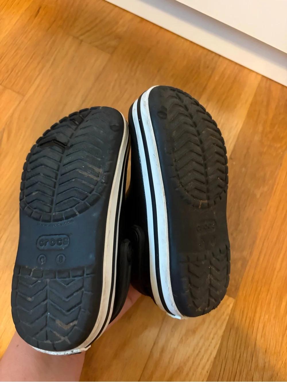 Kid’s black Croc slip on shoe with white band size 8